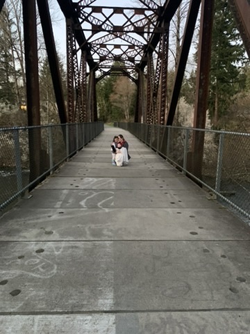 Jody and her kids on an old steel railroad bridge along the Cedar River Trail