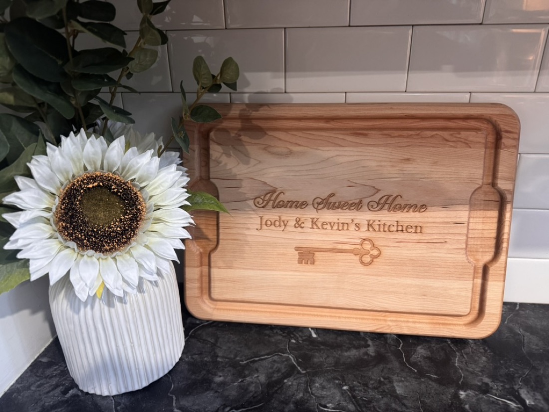 Engraved cutting board reading Home Sweet Home, Jody and Kevin's Kitchen