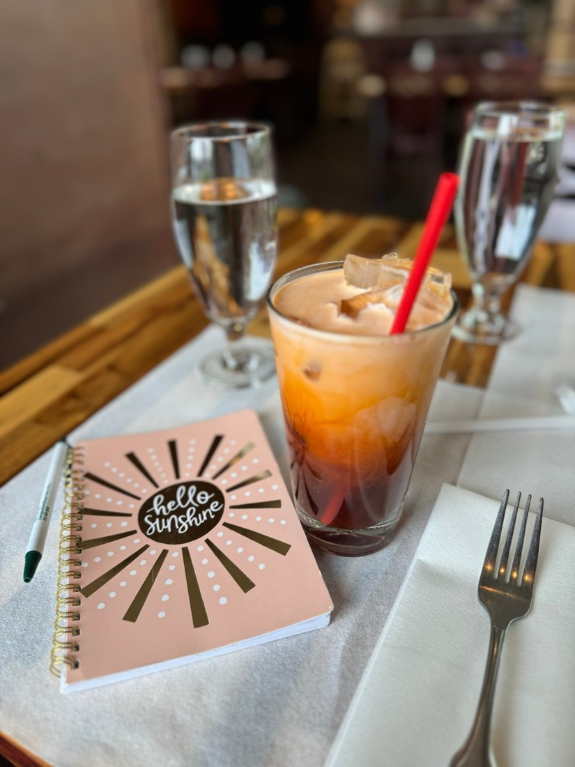 Thai iced tea and a Hello Sunshine notebook at Benjarong Thai Cuisine in Covington