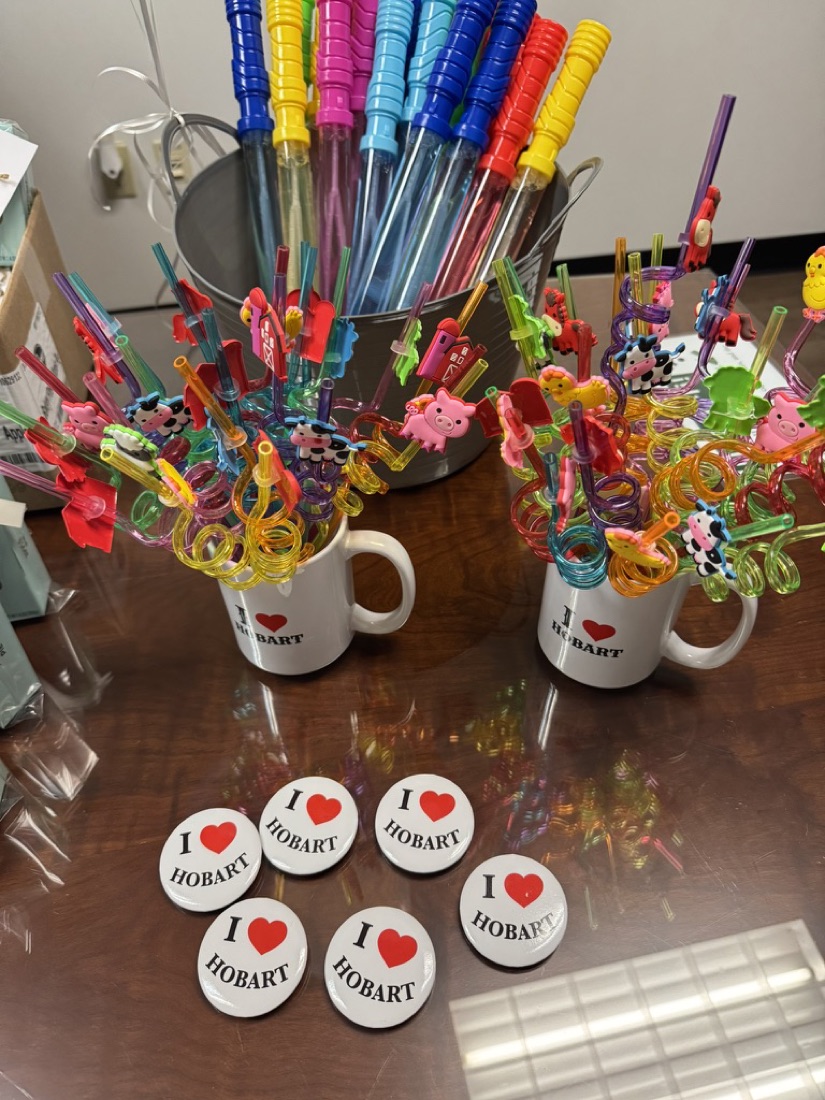 I love Hobart buttons and mugs with fun straws at a Hobart community event