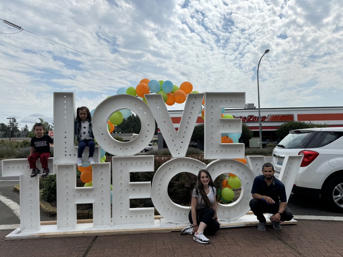 Jody and her family at the Love the COV sign in Covington